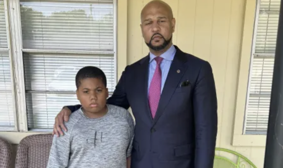 Aderrien Murry, 11, pictured with family attorney Carlos Moore, is recovering at home (Carlos Moore / CNN)