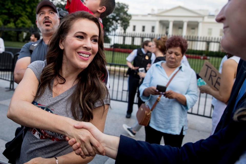Actress Alyssa Milano arrives to speak at an protest outside the White House, Tuesday, July 17, 2018, in Washington. This is the second day in a row the group has held a protest following President Donald Trump's meetings with Russian President Vladimir Putin. (AP Photo/Andrew Harnik) ORG XMIT: DCAH128