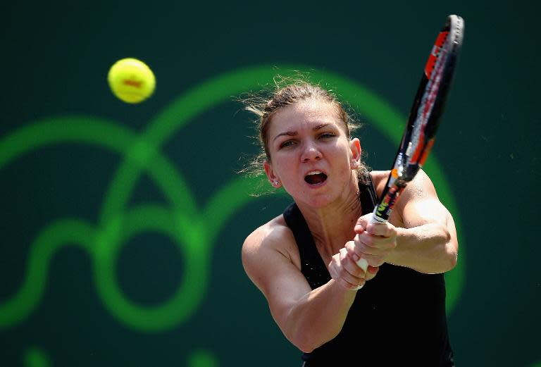 Simona Halep of Romania plays a backhand against Nicole Vaidisova of Czech Republic in their second round match during the Miami Open on March 27, 2015 in Key Biscayne, Florida