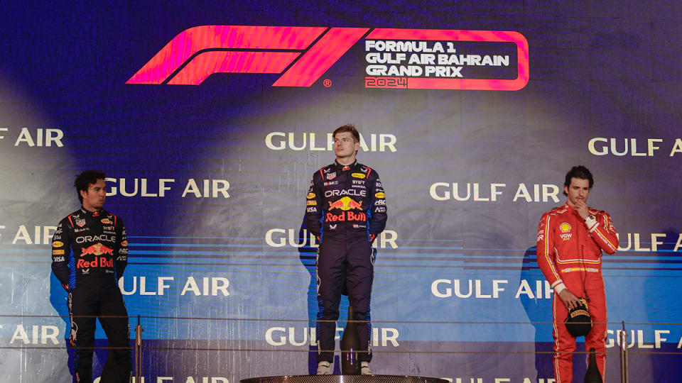 At the 2024 Bahrain Grand Prix, winner Max Verstappen shares the podium stage with Red Bull teammate Sergio Perez, who captured second, and third-place finisher Carlos Sainz of Ferrari.