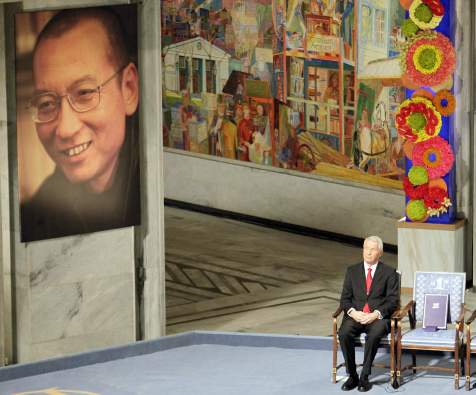 FILE - Nobel Committee chairman Thorbjorn Jagland sits next to an empty chair with the Nobel Peace Prize medal and diploma during a ceremony honoring Nobel Peace Prize laureate Liu Xiaobo in Oslo, Norway, on Dec. 10, 2010. The U.S. State Department has set up an eight-person team known as the "firm" to provide help to countries cut off from Chinese trade. In one example, when the committee awarded the Nobel Peace Prize to Liu Xiaobo, Beijing stopped buying salmon from the Nordic country. (AP Photo/John McConnico, File)