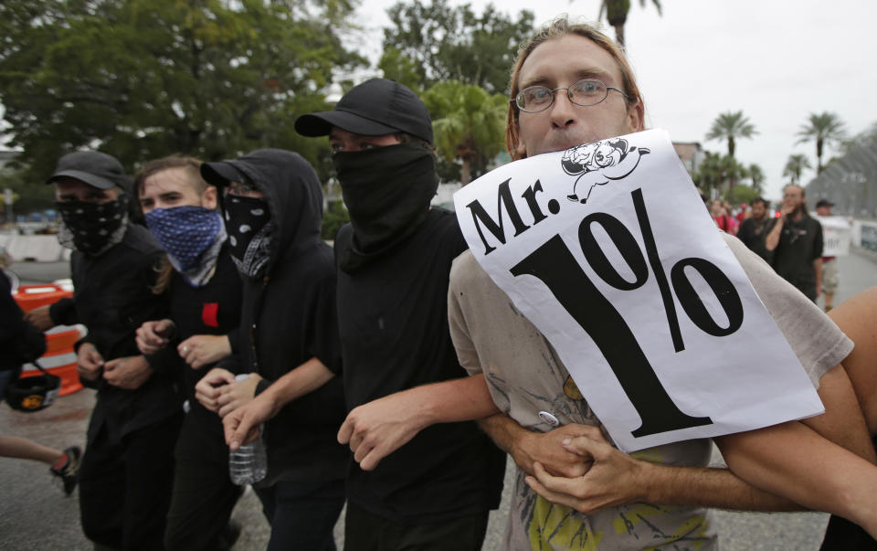 Demonstrators march in downtown St. Petersburg, Fla., Sunday, Aug. 26, 2012. The protestors were demonstrating near Tropicana Field where a welcoming event is taking place for the delegates of the Republican National Convention. (AP Photo/Dave Martin)