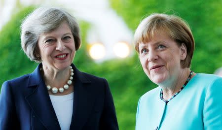 German Chancellor Angela Merkel greets British Prime Minister Theresa May (L) during a welcoming ceremony at the Chancellery in Berlin, Germany July 20, 2016. REUTERS/Hannibal Hanschke/File Photo