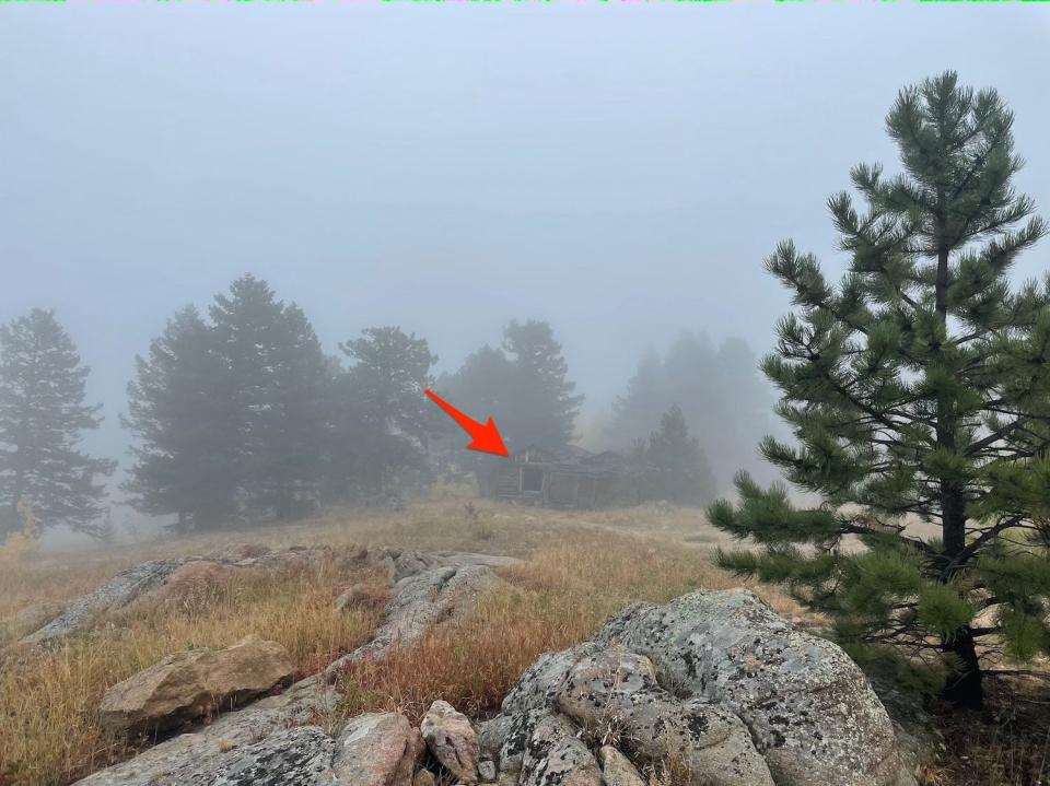 An arrow points to a second house in the fog.