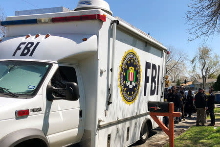 Law enforcement personnel including FBI agents are seen near a home that was hit with a parcel bomb in Austin, Texas, U.S., March 13, 2018. REUTERS/Jon Herskovitz