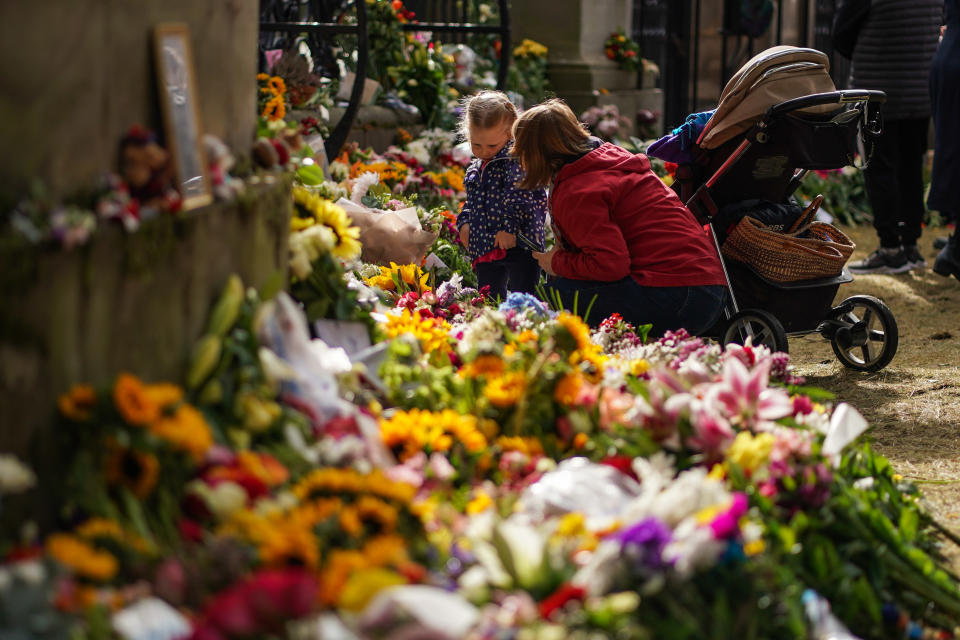 <p>People view flowers which have been laid in remembrance of the late Queen Elizabeth II outside the Palace of Holyroodhouse on September 12, 2022 in Edinburgh, Scotland. (Photo by Peter Summers/Getty Images)</p> 