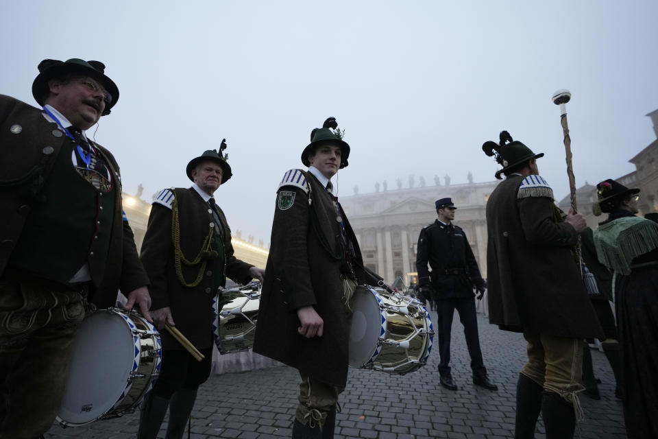 Musicians walk in St. Peter's Square at the Vatican ahead of the funeral mass for late Pope Emeritus Benedict XVI, Thursday, Jan. 5, 2023. Benedict died at 95 on Dec. 31 in the monastery on the Vatican grounds where he had spent nearly all of his decade in retirement, his days mainly devoted to prayer and reflection. (AP Photo/Alessandra Tarantino)