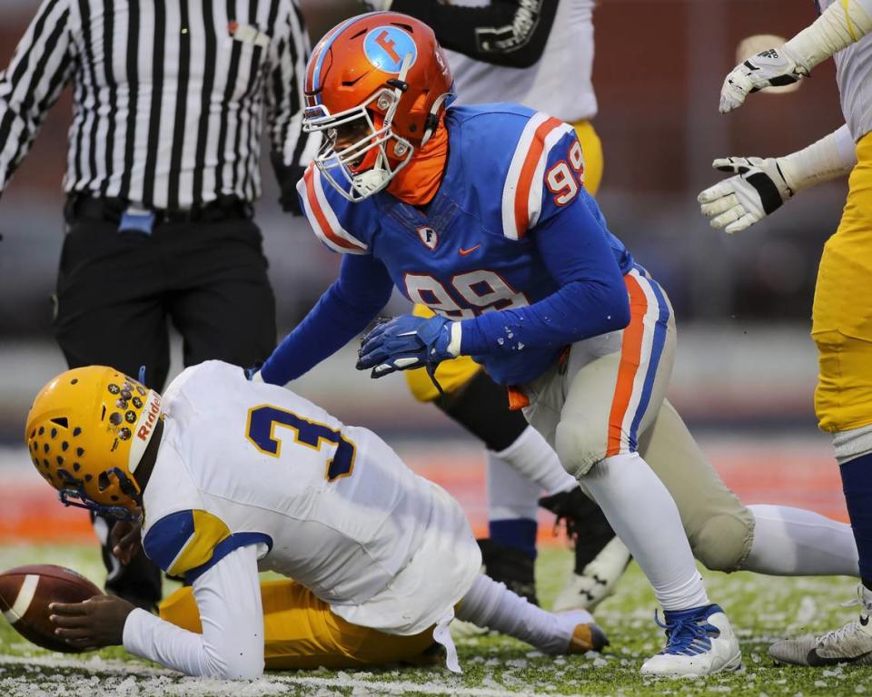 November 12, 2022 - East St. Louis, IL - East St. Louis defensive end Keandre McClendon sacks the Crete Monee quarterback during the IHSA, 6A, Quarterfinal playoff game between Crete - Monee and East St. Louis. The 45-0 victory will advance the Flyers to the Semifinals. [Photo: Chris Johns]