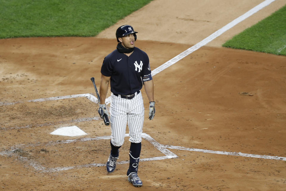 New York Yankees designated hitter Giancarlo Stanton walks back to the dugout after striking out during an intrasquad baseball game Monday, July 6, 2020, at Yankee Stadium in New York. (AP Photo/Kathy Willens)