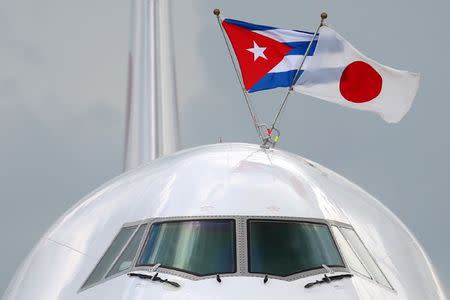 Cuban and Japanese flags are displayed on top of the airplane bringing Japan's Prime Minister Shinzo Abe upon his arrival at the Jose Marti International Airport in Havana, Cuba, September 22, 2016. REUTERS/Alexandre Meneghini