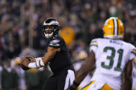 Philadelphia Eagles quarterback Jalen Hurts (1) throws a touchdown pass during the second half of an NFL football game against the Green Bay Packers, Sunday, Nov. 27, 2022, in Philadelphia. (AP Photo/Matt Slocum)