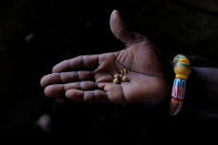 FILE PHOTO: A hand of a person holds gold after it has been processed with mercury and nitric acid in Bawdie