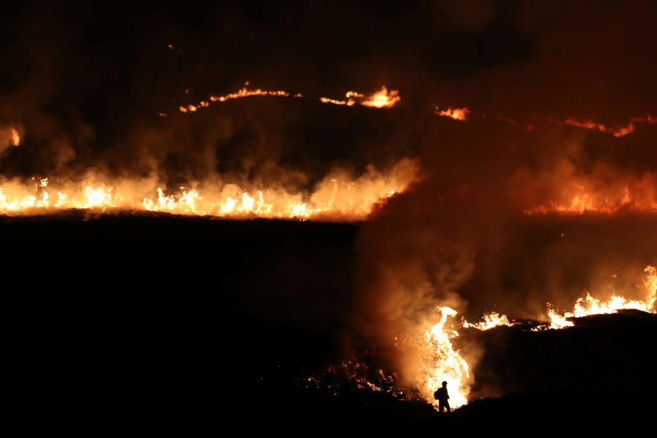 A fire is seen burning on Saddleworth Moor near the town of Diggle. Source: Reuters