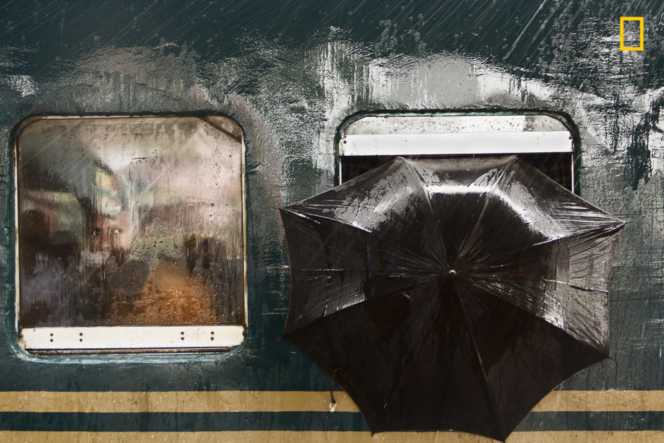 "The photo was taken on 23rd of July 2016 at Tongi Railway Station, Gazipur, Bangladesh. I was there taking photos and waiting for a moment. A train from Dhaka toward another district had reached and stopped at the platform for 5 minutes for lifting passengers. It was raining. Suddenly I found a pair of curious eyes looking at me through the window, and on his left an umbrella had&nbsp;been put to&nbsp;protect from the rain. I got the moment." ― <a href="http://yourshot.nationalgeographic.com/profile/881042/" target="_blank">Moin Ahmed</a>&nbsp;(<a href="http://travel.nationalgeographic.com/photographer-of-the-year-2017/gallery/winners-all/13" target="_blank">Honorable mention, People</a>)
