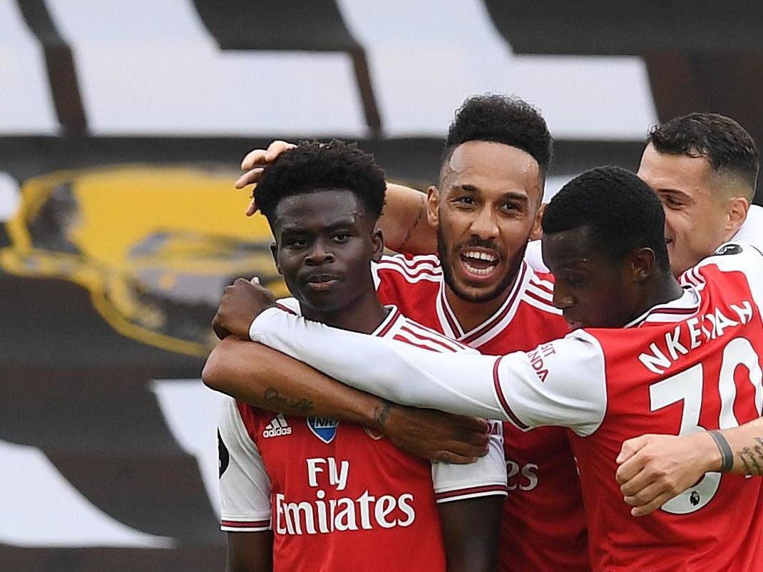 Arsenal celebrate after Bukayo Saka (left) scores: Getty