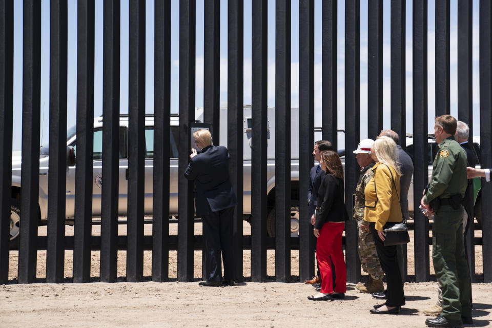 El presidente Donald Trump pone su firma en una parte del muro fronterizo durante un recorrido en San Luis, Arizona, el martes 23 de junio de 2020. (AP Foto/Evan Vucci)