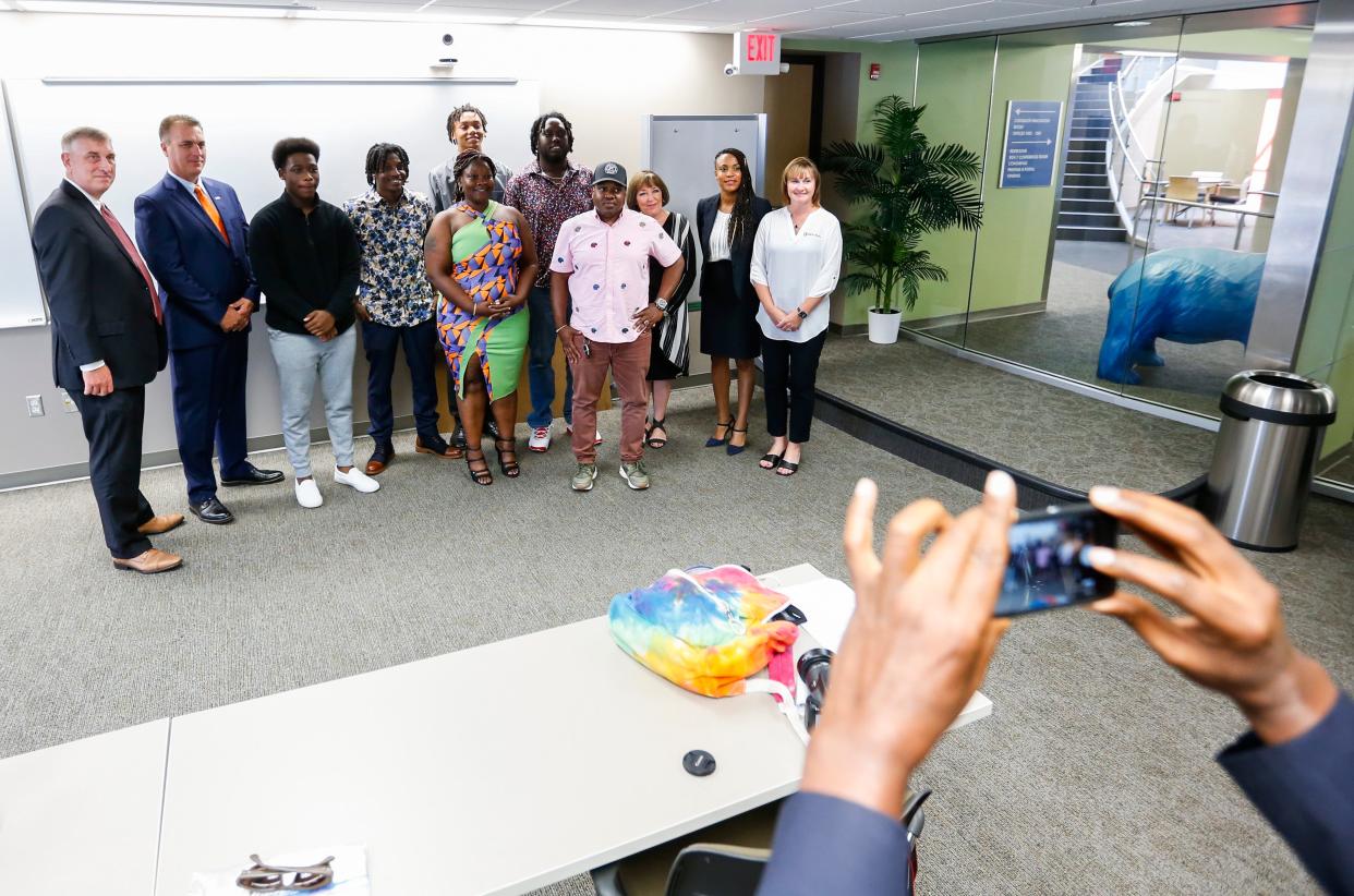 Winners of the ASCEND diversity small business grants pose for photos with officials from the Downtown Springfield Association, Minorities in Business, and U.S. Bank on Tuesday, June 28, 2022. The grant recipients, Eway Scooters, Jamaican Patty, MD Hair Supplies, Mimi's Soul Food and Bell's Marketing Consultant, all will receive $5,000.