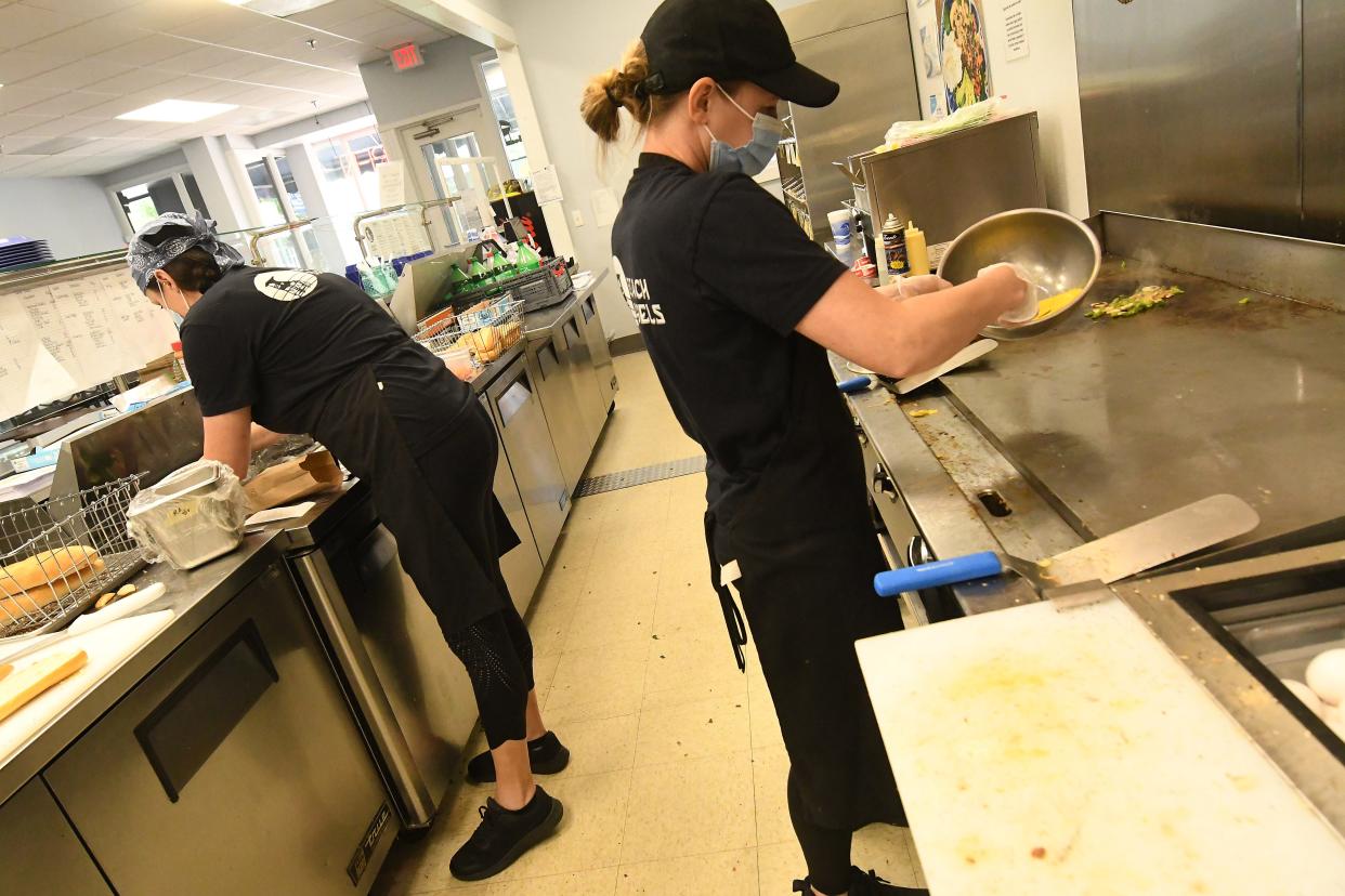 Workers cook up subs and bagel sandwiches at Beach Bagels in downtown Wilmington in this StarNews file photo.