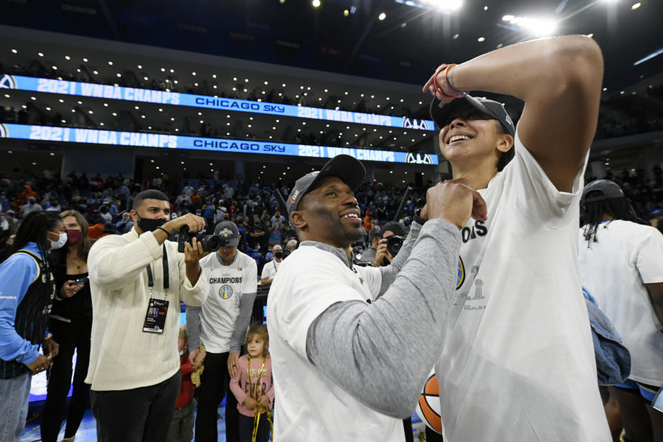 Chicago Sky head coach James Wade, front left, celebrates with Candice Parker, right, after defeating the Phoenix Mercury in Game 4 of the WNBA Finals to become champions Sunday, Oct. 17, 2021, in Chicago. (AP Photo/Paul Beaty)