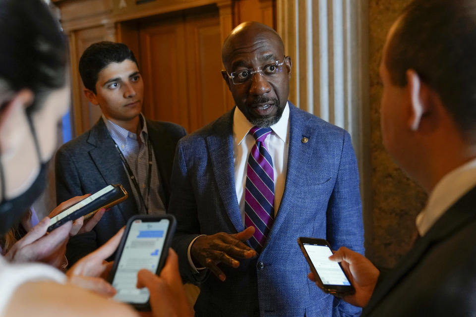 Sen. Raphael Warnock, D-Ga., speaks with reporters on Capitol Hill in Washington, Saturday, Aug. 6, 2022. (AP Photo/Patrick Semansky)