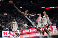 San Antonio Spurs center Victor Wembanyama (1) reaches for a pass during overtime in the team's NBA basketball game against the Houston Rockets in San Antonio, Friday, Oct. 27, 2023. (AP Photo/Eric Gay)