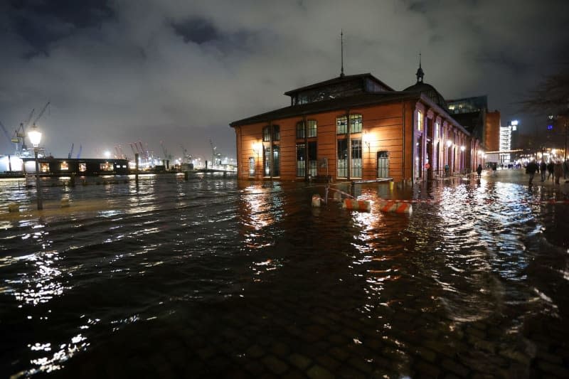 The fish market in Hamburg is seen flooded as storm "Zoltan" surges. Bodo Marks/dpa