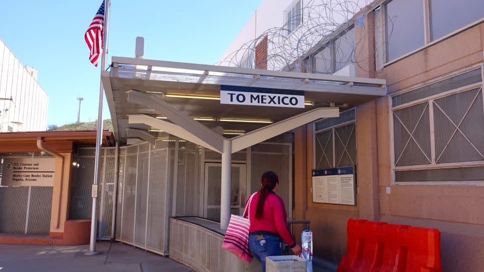 A person walks through the pedestrian crossing to Mexico at the Nogales-Morley Gate in Nogales, Arizona. - CNN