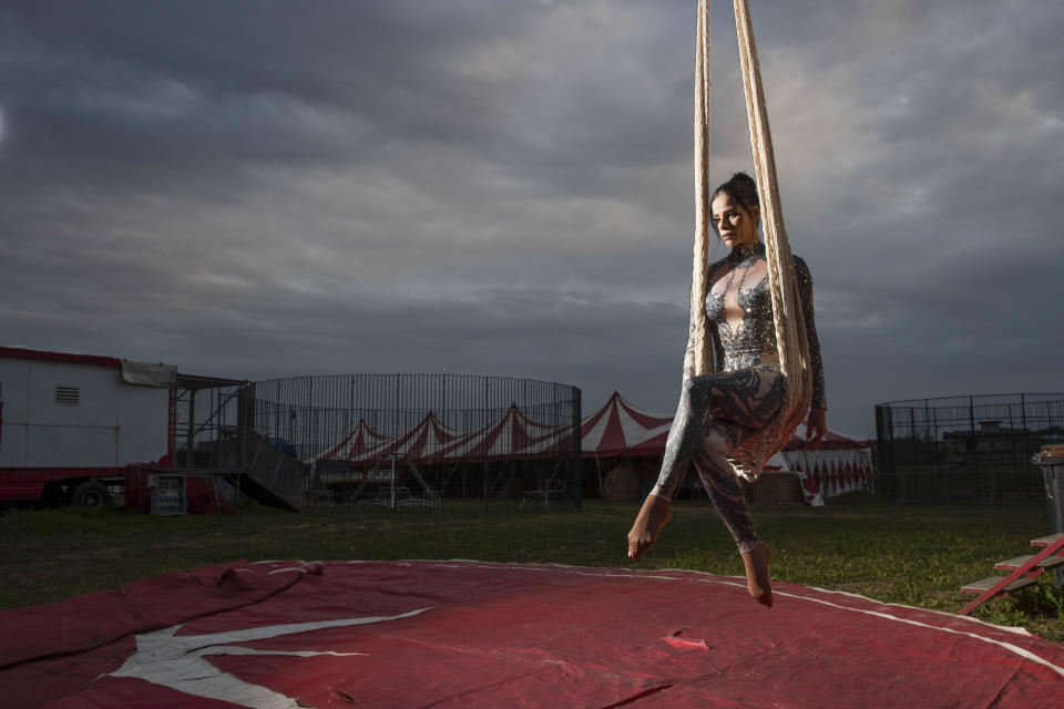 Otilia Maria Martinez Dos Santos, an artist of Portuguese origin, poses for a portrait at the Rony Roller circus, parked in the outskirts of Rome, Saturday, April 18, 2020. Photographer Alessandra Tarantino said she came up with the idea to shoot circus workers after growing frustrated and bored with the postcard-like shots of an empty Rome during lockdown. The shot was taken between poses, with the swing seemingly attached to the sky. “Her empty gaze, lost in the void, deeply affected me. It’s hard to dance without the music,” Tarantino said. (AP Photo/Alessandra Tarantino)