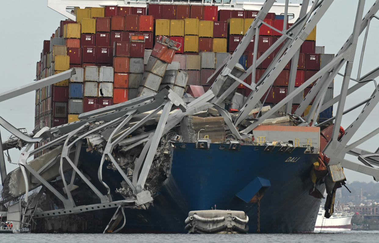 The steel frame of the Francis Scott Key Bridge sits on top of the container ship Dali after the bridge collapsed, Baltimore, Maryland, on March 26, 2024.