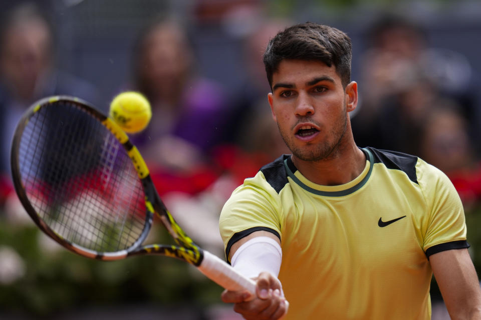 Carlos Alcaraz, of Spain, returns the ball to Alexander Shevchenko, of Kazakhstan, during the Mutua Madrid Open tennis tournament in Madrid, Friday, April 26, 2024. (AP Photo/Manu Fernandez)