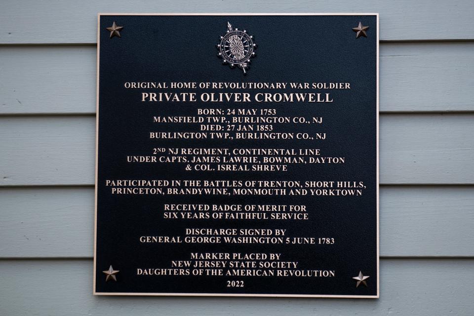 A new bronze plaque honors decorated Revolutionary War soldier Pvt. Oliver Cromwell in Burlington, NJ. The marker installed Wednesday by the New Jersey Society of the Daughters of the American Revolution highlights his war history and his award of the Badge of Merit by Gen. George Washington in 1783.