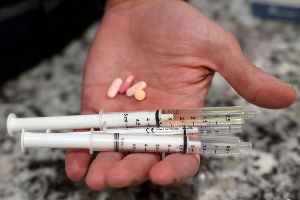 Kyle Sintz holds the nightly doses of medicine for his son Isaac, including Epidiolex cannabidiol, at their home in South Jordan on Wednesday, March 22, 2023. Isaac, 16, has Dravet Syndrome, a severe form of epilepsy. | Kristin Murphy, Deseret News