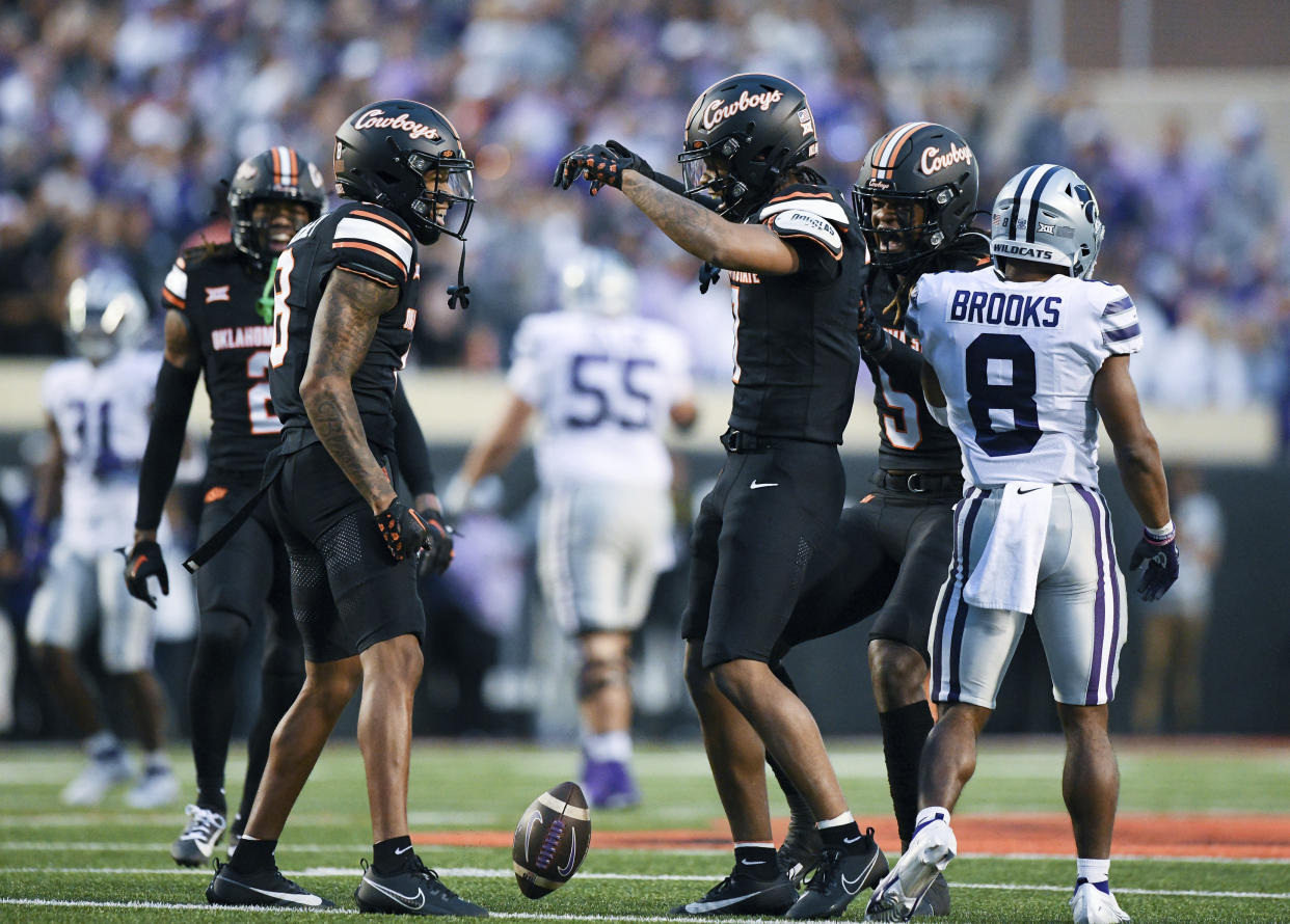 Oklahoma State cornerback D.J. McKinney, left, and safety Cameron Epps celebrate during a game against Kansas State on Friday, Oct. 6, 2023, in Stillwater, Okla. (AP Photo/Brody Schmidt)