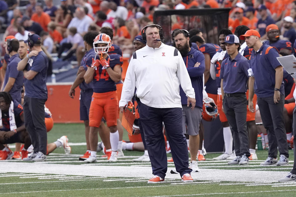 Illinois head coach Brent Bielema, center, looks at the scoreboard during the second half of an NCAA college football game against Virginia, Saturday, Sept. 10, 2022, in Champaign, Ill. (AP Photo/Charles Rex Arbogast)