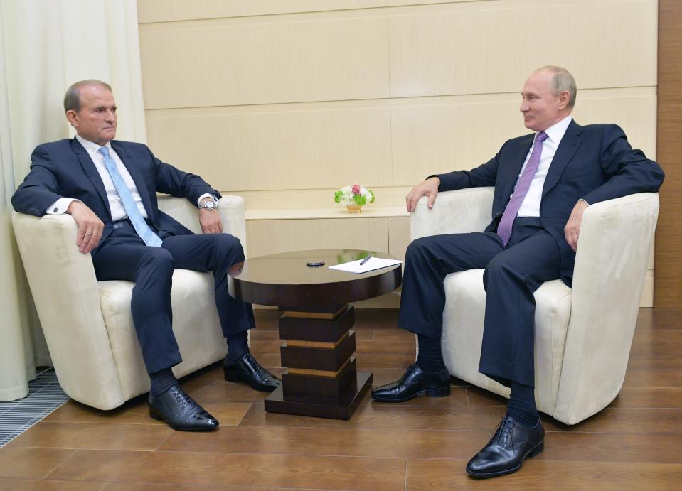 Ukrainian tycoon Viktor Medvedchuk, left, speaks to Russian President Vladimir Putin during a meeting at the Novo-Ogaryovo residence outside Moscow, Russia, Tuesday, Oct. 6, 2020. Medvedchuk, who heads the Opposition Platform for Life party and has close ties with Putin, was placed under house arrest on Thursday, May 13, 2021 by a Ukrainian court on treason charges that he denied(Sputnik, Kremlin Pool Photo via AP)