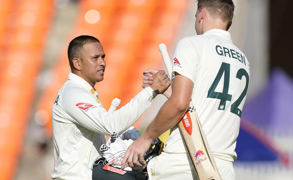 Usman Khawaja and Cameron Green, pictured here walking off the field after the first day of the fourth Test against India. 