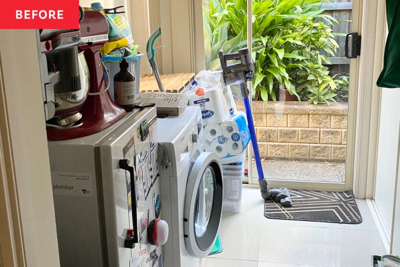 White cluttered laundry room before renovation