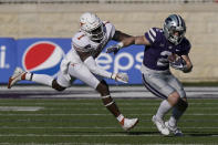 Texas defensive back Chris Adimora (1) catches up with Kansas State running back Harry Trotter (2) during the second half of an NCAA college football game in Manhattan, Kan., Saturday, Dec. 5, 2020. (AP Photo/Orlin Wagner)