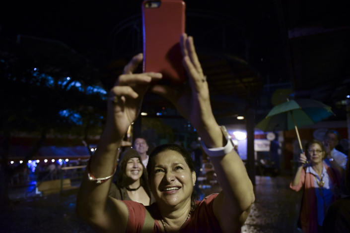 People gather to celebrate after learning that President Barack Obama commuted the sentence for Puerto Rican nationalist Oscar Lopez Rivera, in San Juan, Puerto Rico, Tuesday, Jan. 17, 2017. Many Puerto Ricans have long demanded his release, and some wept with emotion upon hearing the news while others began preparing for all-night parties announced on social media. (AP Photo/Carlos Giusti)