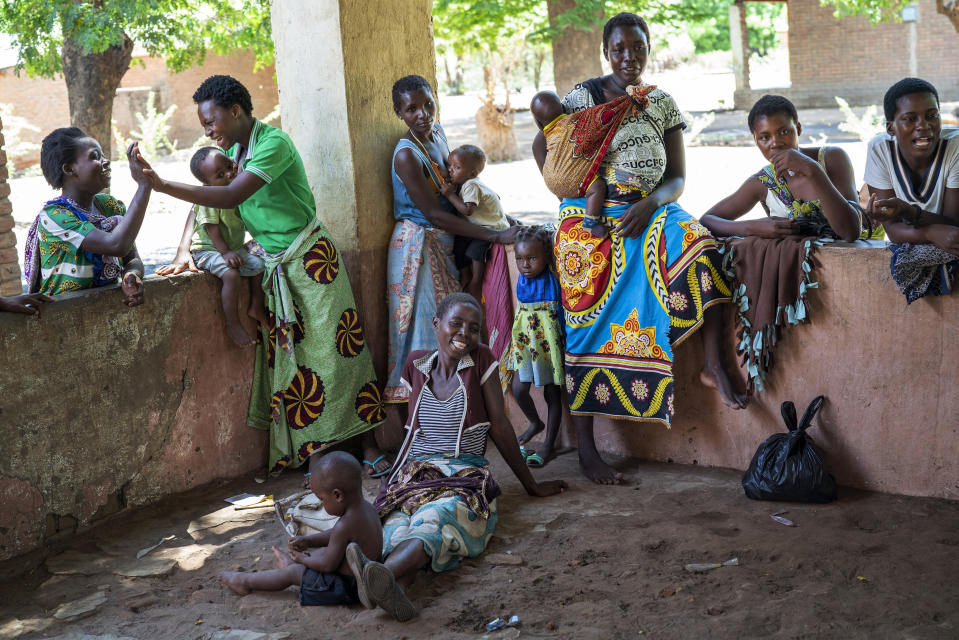 FILE - In this photo taken on Dec. 11, 2019, residents of the Malawi village of Tomali wait to have their young children become test subjects for the world's first vaccine against malaria. The U.N. health agency said Monday, Dec. 6, 2021, that the global response to the longtime threat of malaria has taken a hit as the coronavirus pandemic disrupted health services in many countries, leading to 47,000 more deaths worldwide last year – as questions remain on the possible fallout this year. The World Health Organization, in the latest edition of its World Malaria Report, cited a total of 241 million cases of malaria in 2020, up 14 million from the year before, and 627,000 deaths – an increase of 69,000.(AP Photo/Jerome Delay)