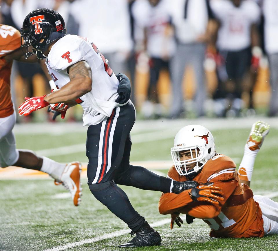 Texas Tech running back DeAndre Washington breaks away from Texas safety Jason Hall during the Red Raiders' 48-45 victory in November 2015 in Austin. This week's Tech-Texas game could be the last in Lubbock for the foreseeable future with Texas departing to the Southeastern Conference in or before 2025.