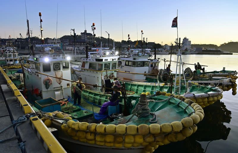 Fishermen work at Matsukawaura fishing port in Soma