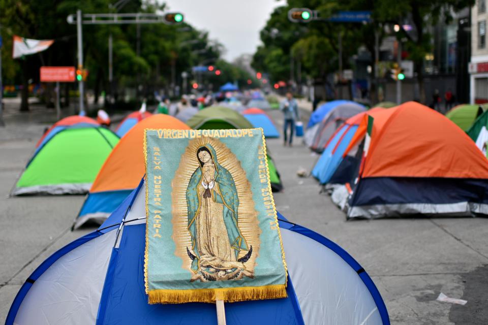 View of a banner depicting the Guadalupe virgin on a tent as members of the National Front Anti-AMLO (Frena), who will make a second attempt to reach Zocalo Square to protest against Mexican President Andres Manuel Lopez Obrador (ALMO), camp on Juarez street in Mexico City on September 20, 2020, a day after being prevented by the local police to get to the city's main square, amid the COVID-19 novel coronavirus pandemic. (Photo by PEDRO PARDO / AFP) (Photo by PEDRO PARDO/AFP via Getty Images)