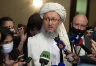 Taliban official Abdul Salam Hanafi, center, speaks to media during talks involving Afghan representatives in Moscow, Russia, Wednesday, Oct. 20, 2021. Russia invited the Taliban and other Afghan parties for talks voicing hope they will help encourage discussions and tackle Afghanistan's challenges. (AP Photo/Alexander Zemlianichenko, Pool)