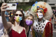 Revelers take part in the Christopher Street Day (CSD) parade, in Berlin, Saturday, July 24, 2021. The official motto of the CSD is "Save our Community - save our Pride". (J'rg Carstensen/dpa via AP)