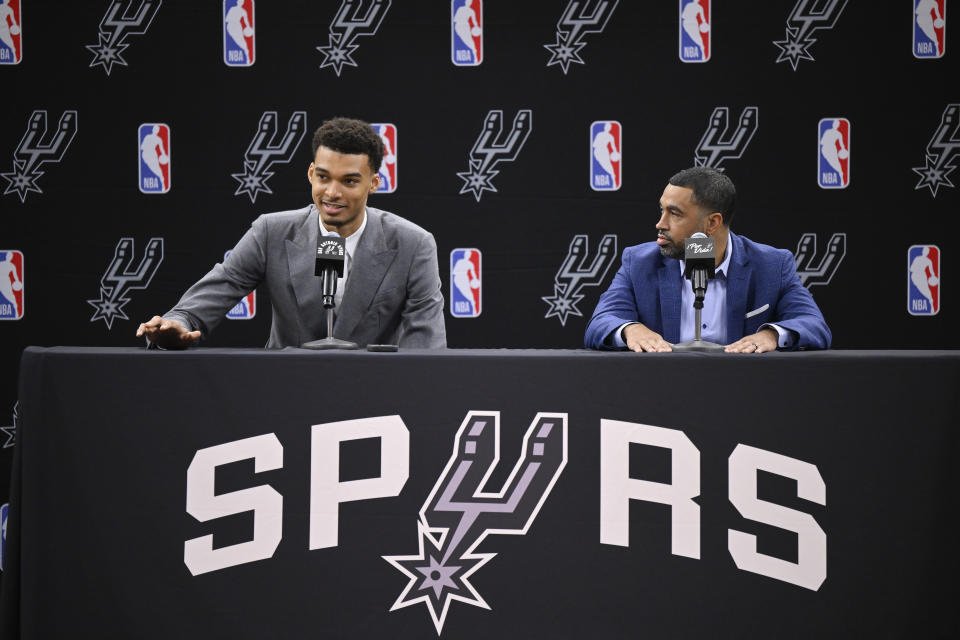 San Antonio Spurs' Victor Wembanyama, left, the No. 1 draft pick, and Spurs general manager Brian Wright, speak during an NBA basketball press conference, Saturday, June 24, 2023, at the AT&T Center in San Antonio. (AP Photo/Darren Abate)