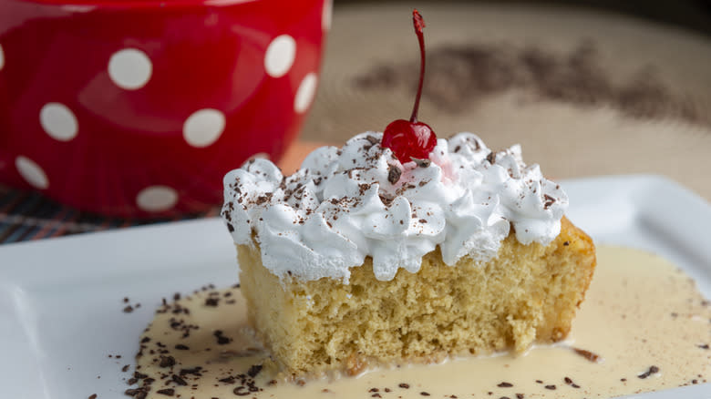 tres leches cake with cherry and shaved chocolate