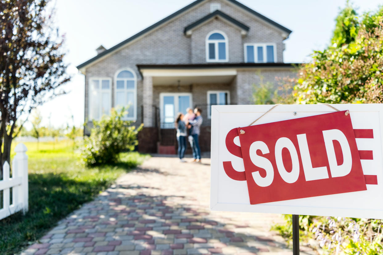 sold house with blurred family on background