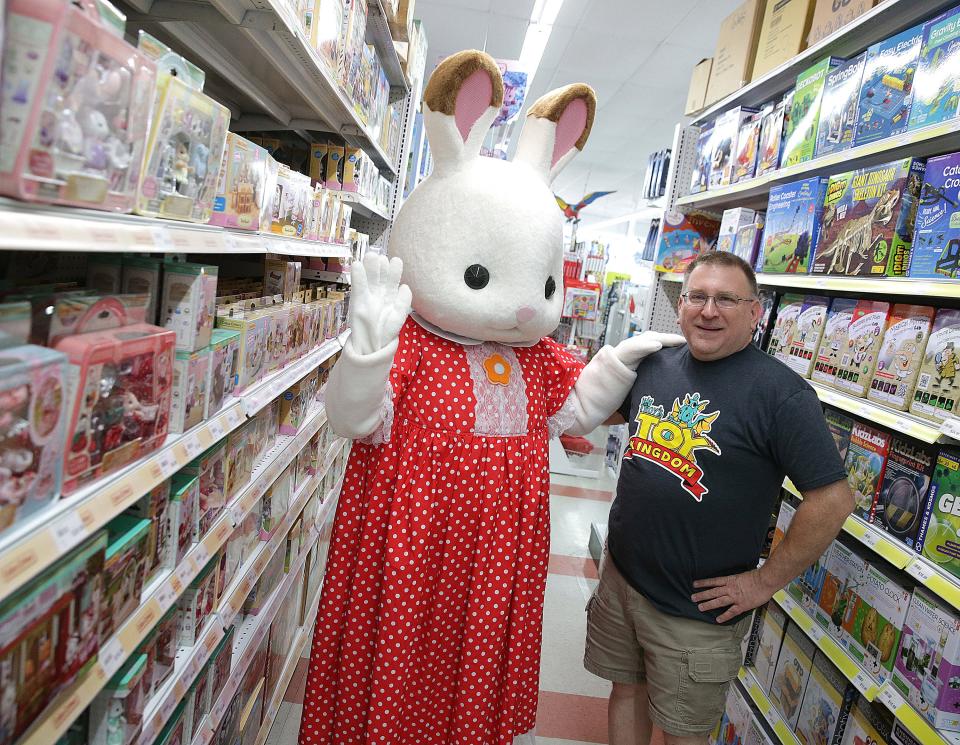 Troy Cefaratti, owner of Sir Troy's Toy Kingdom in North Canton poses with Bell Hopscoth from Calico Critters in the Calico Critter aisle of the store. Plans are to move the store to Belden Village this fall.