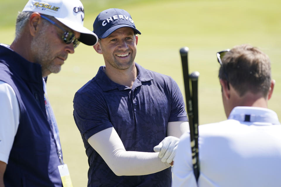 Ben Silverman, of Canada, talks while taking a break on the range during a practice round ahead of the U.S. Open golf tournament, Tuesday, June 14, 2022, at The Country Club in Brookline, Mass. (AP Photo/Charles Krupa)